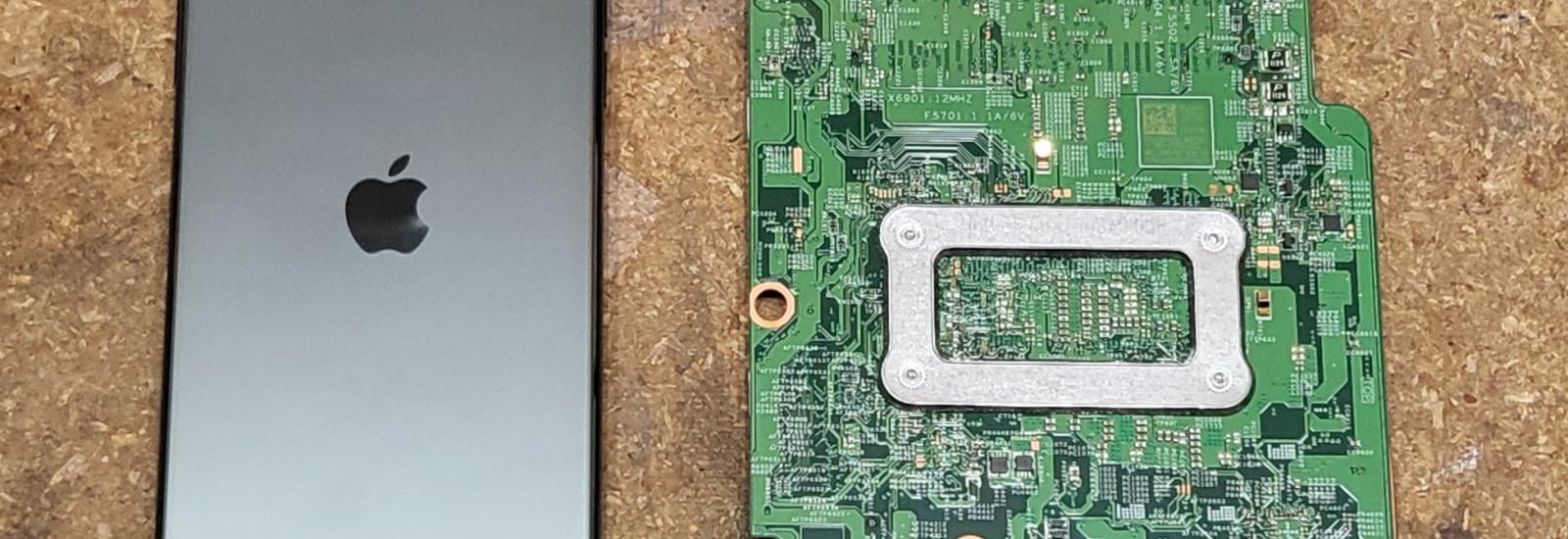 iPhone 11 Pro Max next to Dell Laptop Motherboard